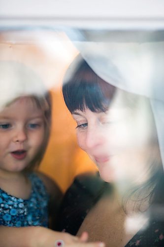 MIKAELA MACKENZIE / WINNIPEG FREE PRESS

Chantal DeGagne and her daughter, Eloïse Krahn (2), pose for a portrait in their window in Winnipeg on Friday, March 27, 2020. They have been self-isolated since March 8th, when the toddler was sick.
Winnipeg Free Press 2020