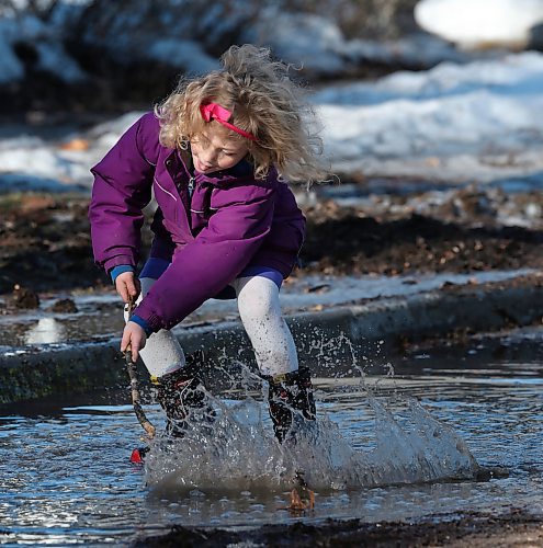 SHANNON VANRAES / WINNIPEG FREE PRESS
Misha Funke-Minkevich plays in a puddle during a "no talent" marching band event on Harvard St. in Winnipeg, March 27, 2020. Neighbours organized the march as a way to stay physically distant, but socially connected.