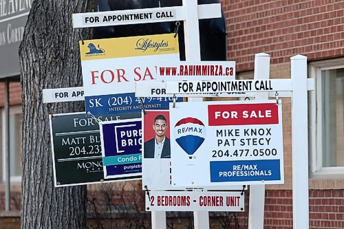 SHANNON VANRAES / WINNIPEG FREE PRESS
Realty signs advertise available condos in front of a building on Corydon Ave. in Winnipeg on March 27, 2020.