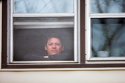 MIKAELA MACKENZIE / WINNIPEG FREE PRESS

Freelance illustrator, designer and cartoonist Jonathan Dyck poses for a portrait in his Wolseley apartment window in Winnipeg on Monday, March 30, 2020. 
Winnipeg Free Press 2020