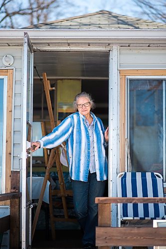 MIKAELA MACKENZIE / WINNIPEG FREE PRESS

Ainslie Davis, Sandy Hook based painter, poses for a portrait in the back doorway of her home (where she paints in the winter with a view of the lake) on Sunday, March 29, 2020. 
Winnipeg Free Press 2020