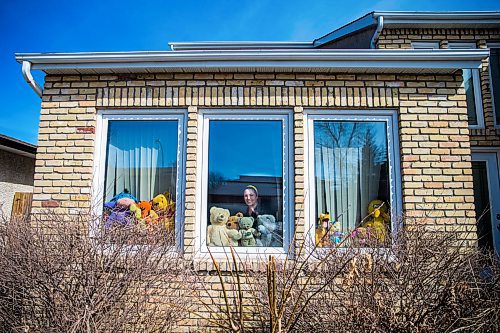 MIKAELA MACKENZIE / WINNIPEG FREE PRESS

Sheilah Restall, who sparked a new initiative called the Great Winnipeg Bear Hunt, poses for a portrait in her front window in Winnipeg on Monday, March 30, 2020. She's encouraging Winnipeggers to put teddy bears in their windows to give kids something to hunt for on neighbourhood walks.
Winnipeg Free Press 2020