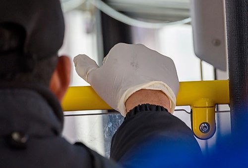 JESSE BOILY / WINNIPEG FREE PRESS
Transit rider wears protective gloves while on a bus on Monday, March 30, 2020. Many riders are trying to keep their distance between each other as social distancing is practiced during the current pandemic. 
Reporter: Eva Wasney