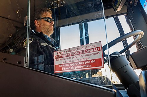 JESSE BOILY / WINNIPEG FREE PRESS
Bill Hadden, a transit driver, drives a bus down Portage Ave behind a protective pelxiglass on Monday, March 30, 2020. Many riders are trying to keep their distance between each other as social distancing is practiced during the current pandemic. 
Reporter: Eva Wasney