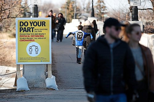 JOHN WOODS / WINNIPEG FREE PRESS
A sign reminding people of keeping their distance during this time of COVID-19 protocols is posted at the Assiniboine Park pedestrian bridge Monday, March 30, 2020. 

Reporter: ?