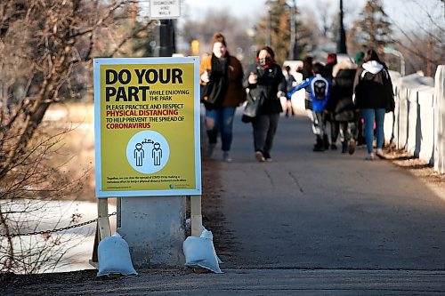 JOHN WOODS / WINNIPEG FREE PRESS
A sign reminding people of keeping their distance during this time of COVID-19 protocols is posted at the Assiniboine Park pedestrian bridge Monday, March 30, 2020. 

Reporter: ?