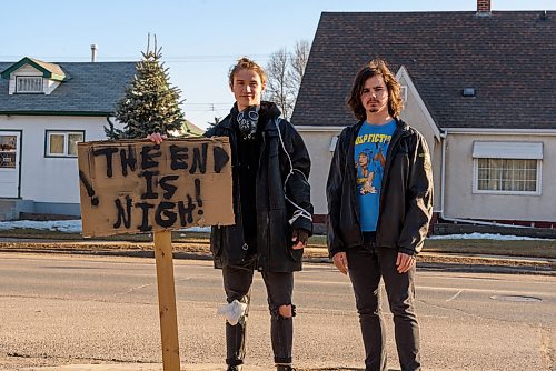 JESSE BOILY / WINNIPEG FREE PRESS
Local film makers Liam Flamand, left and Christian Stevenson stop for a photo on Mountain Ave. on Monday, March 30, 2020. Flamand was wearing a gas mask and holding a sign that says The end is nigh. He explained that he was doing it as guerrilla marketing for his upcoming film, and that it ties well with current events. 
Reporter: n/a