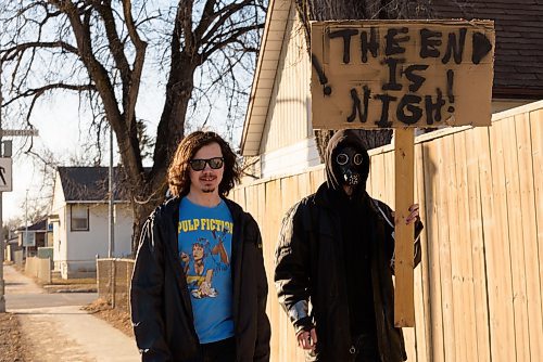 JESSE BOILY / WINNIPEG FREE PRESS
Local film makers Christian Stevenson, left, and Liam Flamand walk along Mountain Ave. With there The end is nigh sign on Monday, March 30, 2020. Flamand explained that he was doing it as guerrilla marketing for his upcoming film, and that it ties well with current events. 
Reporter: n/a