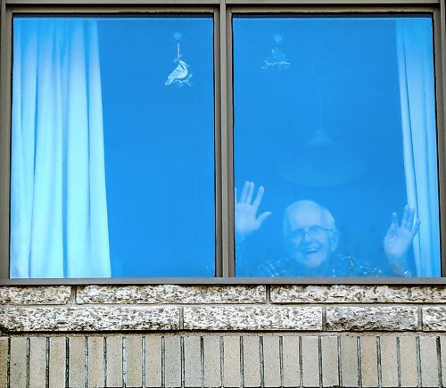 RUTH BONNEVILLE  /  WINNIPEG FREE PRESS 

Local - 101-year-old waving 

Photo of  care home resident, 101-year-old David Thompson,  waving from his 3rd story window at Misericordia Place on Tuesday.

Story on Misericordia calling for donations to help get ipads for residents wanting to visit their families.
101-year-old David Thompson  one of about 100 long-term residents isolated at the Winnipeg centre's personal care home, Misericordia Place.

See Doug Speirs story. 

March 31st,, 2020
