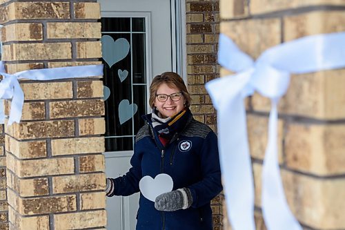 JESSE BOILY / WINNIPEG FREE PRESS
Karen Schellenberg, a pastor at Charleswood Mennonite Church, poses out side her home with her whiteout hearts in support of healthcare and essential workers on Thursday, April 2, 2020. She is encouraging others to do the same and place the hearts on their windows and doors. 
Reporter: Malak Abas