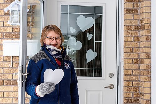 JESSE BOILY / WINNIPEG FREE PRESS
Karen Schellenberg, a pastor at Charleswood Mennonite Church, poses out side her home with her whiteout hearts in support of healthcare and essential workers on Thursday, April 2, 2020. She is encouraging others to do the same and place the hearts on their windows and doors. 
Reporter: Malak Abas
