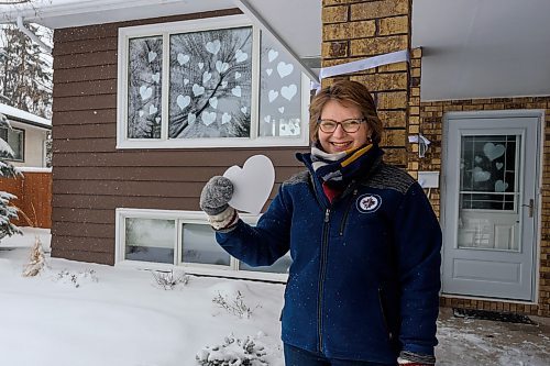 JESSE BOILY / WINNIPEG FREE PRESS
Karen Schellenberg, a pastor at Charleswood Mennonite Church, poses out side her home with her whiteout hearts in support of healthcare and essential workers on Thursday, April 2, 2020. She is encouraging others to do the same and place the hearts on their windows and doors. 
Reporter: Malak Abas