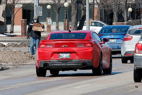 JOHN WOODS / WINNIPEG FREE PRESS
A masked man asks for money at Portage and Sherbrook during COVID-19 in Winnipeg Sunday, April 5, 2020. 

Reporter: Taylor