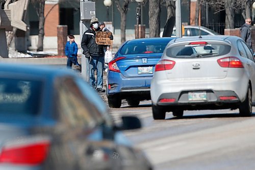 JOHN WOODS / WINNIPEG FREE PRESS
A masked man asks for money at Portage and Sherbrook during COVID-19 in Winnipeg Sunday, April 5, 2020. 

Reporter: Taylor