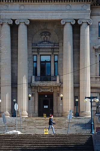 MIKE DEAL / WINNIPEG FREE PRESS
A person wearing a mask walks past the Manitoba Legislative Building Tuesday afternoon.
200407 - Tuesday, April 07, 2020.