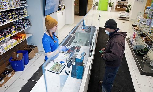 MIKE DEAL / WINNIPEG FREE PRESS
Cannabis Consultant, Brooklyn, serves a customer Tuesday. The Delta 9 Cannabis shop on River Avenue is staying open, now also offering "click and collect" service so people do not have to spend a lot of time lingering in store.
See Martin Cash story
200407 - Tuesday, April 07, 2020.