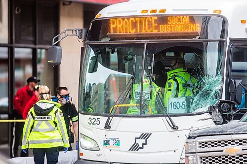 MIKAELA MACKENZIE / WINNIPEG FREE PRESS

Paramedics on the scene of an accident involving two city buses and a truck at Portage Avenue and Vaughan Street in Winnipeg on Tuesday, April 7, 2020. 
Winnipeg Free Press 2020