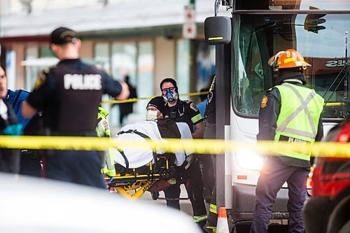 MIKAELA MACKENZIE / WINNIPEG FREE PRESS

Paramedics on the scene of an accident involving two city buses and a truck at Portage Avenue and Vaughan Street in Winnipeg on Tuesday, April 7, 2020. 
Winnipeg Free Press 2020