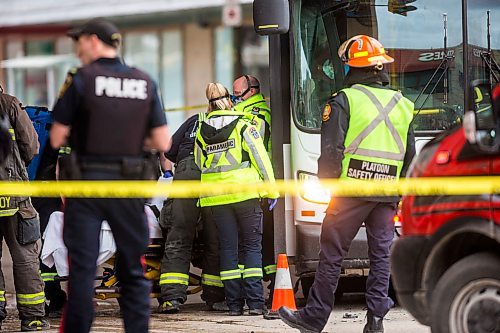 MIKAELA MACKENZIE / WINNIPEG FREE PRESS

Paramedics on the scene of an accident involving two city buses and a truck at Portage Avenue and Vaughan Street in Winnipeg on Tuesday, April 7, 2020. 
Winnipeg Free Press 2020