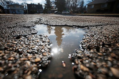 JOHN WOODS / WINNIPEG FREE PRESS
Cars pass a pothole on Rossmere Crescent in Winnipeg Wednesday, April 8, 2020. 

Reporter: ?