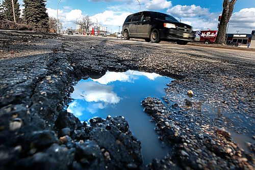 JOHN WOODS / WINNIPEG FREE PRESS
Cars pass a pothole on Henderson in Winnipeg Wednesday, April 8, 2020. 

Reporter: ?