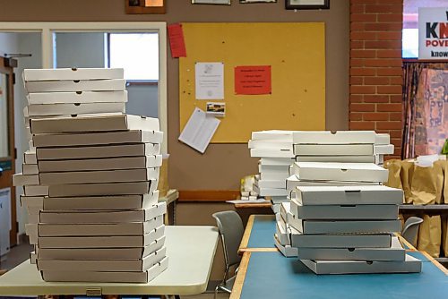 JESSE BOILY  / WINNIPEG FREE PRESS
Stacks of pizza before they are handed out at  the 1JustCity lunch program at their West Broadway Community Ministry on Friday. It was the first time that they had their service open on Good Friday but due to the pandemic and food shortages they deemed it important to stay open. Friday, April 10, 2020.
Reporter:n/a