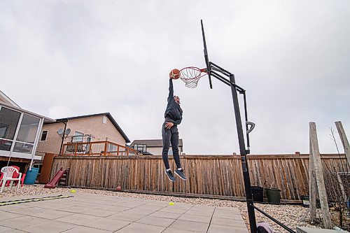 Mike Sudoma / Winnipeg Free Press
Team Manitoba Basketball guard, Lorence dela Cruz warms up with some dunks in his backyard court Tuesday afternoon
April 14, 2020