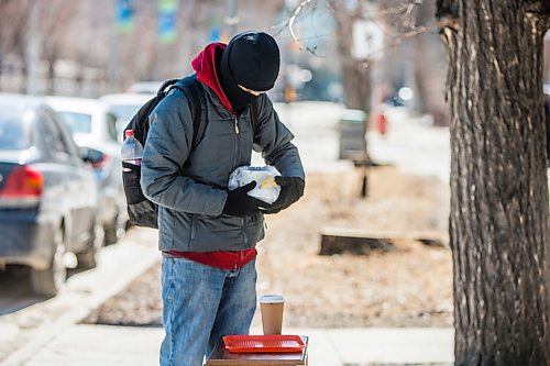 MIKAELA MACKENZIE / WINNIPEG FREE PRESS

Chris Bo picks up a free lunch at Knox Church in Winnipeg on Wednesday, April 15, 2020. For Brenda Suderman story.
Winnipeg Free Press 2020