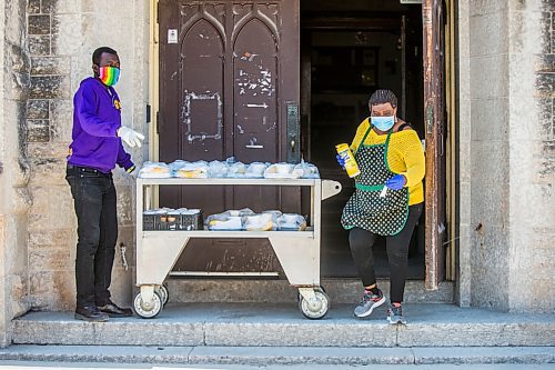 MIKAELA MACKENZIE / WINNIPEG FREE PRESS

Raymond Ngabou (left) and Melrose Koineh serve up free lunch at Knox Church in Winnipeg on Wednesday, April 15, 2020. For Brenda Suderman story.
Winnipeg Free Press 2020