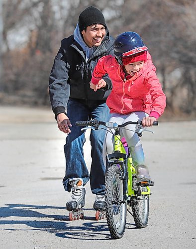 RUTH BONNEVILLE  /  WINNIPEG FREE PRESS 

Standup - rollerblade pull

Ten-year-old Chenigwa pulls her step dad, Andrew Courchene, on rollerblades as she rides her bike while playing outside with their family near their home in St. Norbert Wednesday.  

April 15h,  2020
