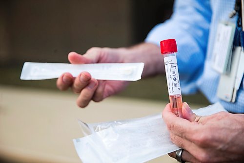 MIKAELA MACKENZIE / WINNIPEG FREE PRESS

Dr. Paul Van Caeseele, assistant director of Cadham Provincial Laboratory, holds a swab and transport agent in front of the lab in Winnipeg on Thursday, April 16, 2020. For Dylan Robertson story.
Winnipeg Free Press 2020