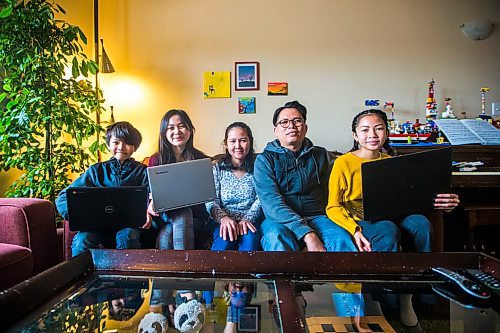 MIKAELA MACKENZIE / WINNIPEG FREE PRESS

Daniel Lampa (left, 9), Maggie Lampa (15), Angie Lampa, Felix Lampa, and Niqui Lampa (13), pose for a photo in their home in Winnipeg on Tuesday, April 21, 2020. Seven Oaks school division lent Daniel Lampa a Chromebook, as all three children need devices to do their schoolwork from home. For Maggie story.
Winnipeg Free Press 2020