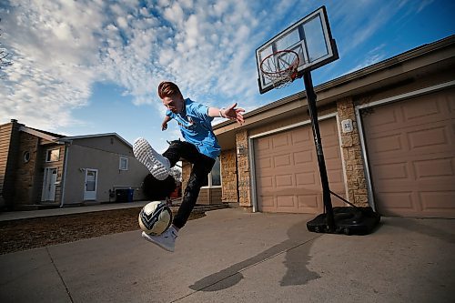 JOHN WOODS / WINNIPEG FREE PRESS
Ethan Hogsden, 15, a minor soccer player with the Winnipeg Phoenix FC, practices on his driveway in Winnipeg Tuesday, April 21, 2020. COVID-19 has shutdown minor sports and left young players to their own devices.

Reporter: Bell