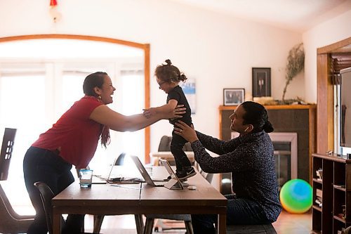 MIKAELA MACKENZIE / WINNIPEG FREE PRESS

Wab Kinew passes his his one-year-old, Tobasonakwut Kinew, over to his wife, Lisa Kinew, while he works from home in Winnipeg on Thursday, April 23, 2020. 
Winnipeg Free Press 2020
