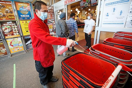 JOHN WOODS / WINNIPEG FREE PRESS
Ronald Napiza disinfects baskets as Edwin Mendoza takes temperatures at Seafood City in Winnipeg Thursday, April 23, 2020. Seafood City have taken great steps to ensure the safety of their customers and staff.

Reporter: Abas
