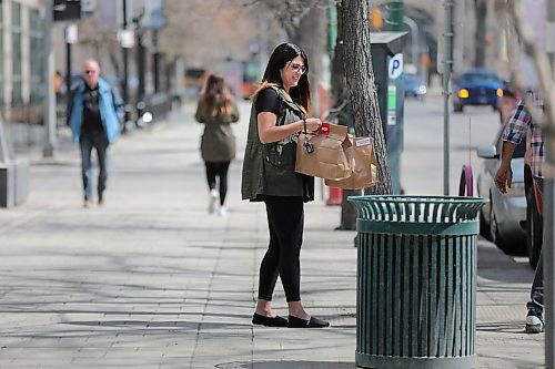 RUTH BONNEVILLE  /  WINNIPEG FREE PRESS 

LOCAL -  Broadway with COVID 

Natalie Gosselin picks up take out food she ordered for her and her colleague over the lunch hour Friday.  Normally Gosselin and her colleagues would be buying their lunch from a food truck.

 Broadway is usually a bustling mecca of  food trucks, area workers enjoying their lunch and pedestrians filling the sidewalks, but now it's a dusty and forlorn avenue during COVID-19 crisis.   

   
April 24th,  2020
