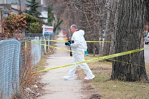 Daniel Crump / Winnipeg Free Press. A Winnipeg police homicide unit investigator carries a camera at a taped off crime scene on Victor Street. Police are investigating the citys 14 homicide of the year. April 25, 2020.