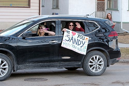 Well-wishers in one of more than 50 vehicles in an evening parade salute Sandy Cook, who retired as a corrections officer at Headingley Correctional Centre on April 24, 2020, in front of her West End home the same day. (See Waldman story)