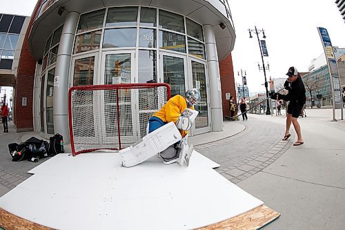 JOHN WOODS / WINNIPEG FREE PRESS
College goaltender Travis Ridgen takes shot from his coach Guy St Vincent in front of a downtown arena Monday, April 27, 2020. Ridgen wanted a little practice and footage for his video channel so what better way than on synthetic ice in front of the home of the Winnipeg Jets.

Reporter: Sawatzky