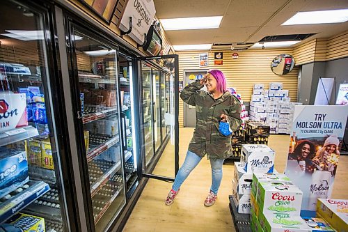 MIKAELA MACKENZIE / WINNIPEG FREE PRESS

Mercedes Hall, acting manager of the Norwood Hotel  Beer Store, shows the empty fridges in Winnipeg on Tuesday, April 28, 2020. They've had to unplug seven fridges because there isn't stock to fill them with. For Eva Wasney story.

Winnipeg Free Press 2020