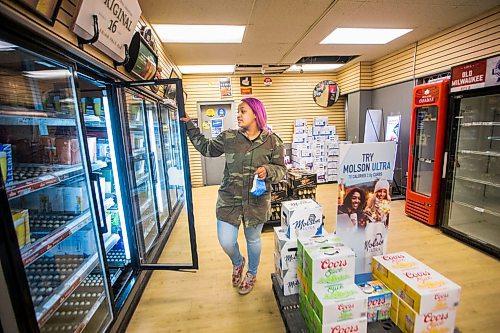 MIKAELA MACKENZIE / WINNIPEG FREE PRESS

Mercedes Hall, acting manager of the Norwood Hotel  Beer Store, shows the empty fridges in Winnipeg on Tuesday, April 28, 2020. They've had to unplug seven fridges because there isn't stock to fill them with. For Eva Wasney story.

Winnipeg Free Press 2020