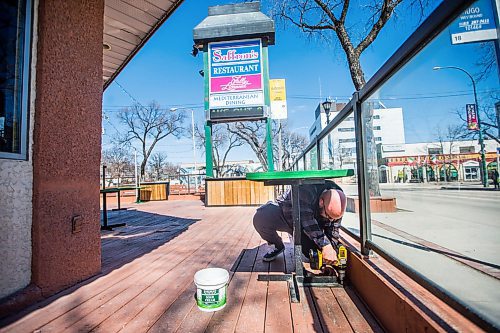 MIKAELA MACKENZIE / WINNIPEG FREE PRESS

Denny Kolevris, manager, bolts tables down on the patio at Saffron's in Winnipeg on Wednesday, April 29, 2020. Patios are opening for business on Monday. For Kevin Rollason story.

Winnipeg Free Press 2020