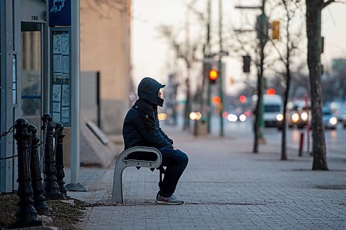 Mike Sudoma / Winnipeg Free Press
A man waits along for his bus on Main St Tuesday evening
April 29, 2020