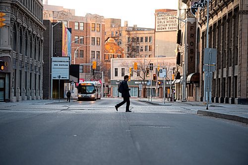 Mike Sudoma / Winnipeg Free Press
A man walks across Garry St while making his way down Portage Ave Tuesday evening
April 29, 2020