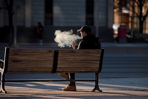 Mike Sudoma / Winnipeg Free Press
A man blows a cloud of vape smoke while waiting for his bus on Main St Tuesday evening
April 29, 2020