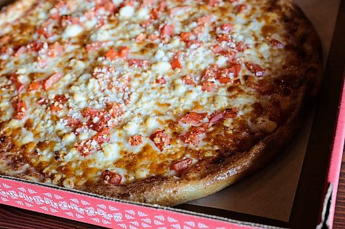 Daniel Crump / Winnipeg Free Press. A large tomato and feta pizza from A Little Pizza Heaven. April 30, 2020.
