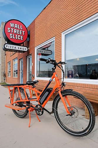 Daniel Crump / Winnipeg Free Press. Wall Street Slice has been using a bright orange electric bicycle to deliver pizzas since mid-April. The bike is affectionately known as Sparky. April 30, 2020.