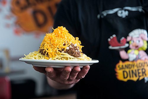 MIKAELA MACKENZIE / WINNIPEG FREE PRESS

Fraser Mason, owner of Sandy Lou's Diner, shows off a plate of Cincinnati-style chili in Winnipeg on Friday, May 1, 2020. The diner's only been open six months, but has already had its share of adversity, first getting into a dispute with their original landlord at a downtown hotel, forcing them to vacate that premises after only three months, then getting hit with COVID two weeks after opening at their second location, inside the LaSalle Hotel. For Dave Sanderson story.

Winnipeg Free Press 2020