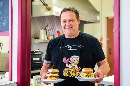 MIKAELA MACKENZIE / WINNIPEG FREE PRESS

Fraser Mason, owner of Sandy Lou's Diner, brings out a couple of burgers from the kitchen in Winnipeg on Friday, May 1, 2020. The diner's only been open six months, but has already had its share of adversity, first getting into a dispute with their original landlord at a downtown hotel, forcing them to vacate that premises after only three months, then getting hit with COVID two weeks after opening at their second location, inside the LaSalle Hotel. For Dave Sanderson story.

Winnipeg Free Press 2020