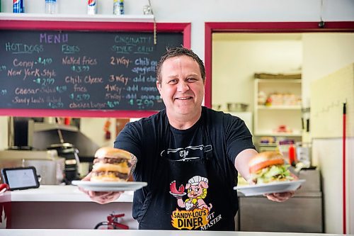 MIKAELA MACKENZIE / WINNIPEG FREE PRESS

Fraser Mason, owner of Sandy Lou's Diner, poses for a portrait with a double cheeseburger and a fatboy in Winnipeg on Friday, May 1, 2020. The diner's only been open six months, but has already had its share of adversity, first getting into a dispute with their original landlord at a downtown hotel, forcing them to vacate that premises after only three months, then getting hit with COVID two weeks after opening at their second location, inside the LaSalle Hotel. For Dave Sanderson story.

Winnipeg Free Press 2020